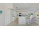 Bright kitchen with white cabinets, stainless steel appliances, and breakfast bar at 3270 Bay Ridge Way, Port Charlotte, FL 33953