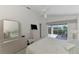 Bedroom with sliding door to patio, ceiling fan, and ensuite bathroom at 3270 Bay Ridge Way, Port Charlotte, FL 33953