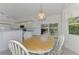 Bright dining area with wood table and chairs, adjacent to kitchen at 3270 Bay Ridge Way, Port Charlotte, FL 33953