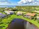 Aerial view showcasing a waterfront community with houses and a pond at 3270 Bay Ridge Way, Port Charlotte, FL 33953