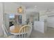 Dining room with wood table and chairs near kitchen and backyard access at 3270 Bay Ridge Way, Port Charlotte, FL 33953