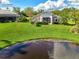 House with lake view in a lush green community at 3270 Bay Ridge Way, Port Charlotte, FL 33953