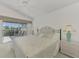 Main bedroom with patio access and ceiling fan, dresser and ensuite bath at 3270 Bay Ridge Way, Port Charlotte, FL 33953