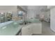 Bright kitchen with island, stainless steel appliances, and view to backyard at 3270 Bay Ridge Way, Port Charlotte, FL 33953