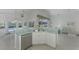 Kitchen features island with double sink, stainless steel dishwasher, and view to backyard at 3270 Bay Ridge Way, Port Charlotte, FL 33953