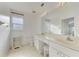 Bathroom boasts double sinks, a toilet and linen storage at 3270 Bay Ridge Way, Port Charlotte, FL 33953