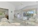 Bright living room with vaulted ceilings, and access to kitchen and patio at 3270 Bay Ridge Way, Port Charlotte, FL 33953