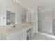 Bright bathroom with double vanity, large mirror, and shower at 3270 Bay Ridge Way, Port Charlotte, FL 33953