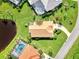 Bird's eye view of a home nestled in a green landscape near a pond at 3270 Bay Ridge Way, Port Charlotte, FL 33953