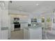 Modern kitchen with white cabinetry, stainless steel appliances and breakfast bar at 3270 Bay Ridge Way, Port Charlotte, FL 33953