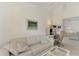 Spacious living room features a couch and access to other rooms at 3270 Bay Ridge Way, Port Charlotte, FL 33953
