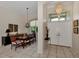 Formal dining room with wood table, chandelier, and access to the entryway at 3479 Pennyroyal Rd, Port Charlotte, FL 33953