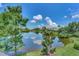 Scenic view of a tranquil lake with lush greenery and homes in the background at 3479 Pennyroyal Rd, Port Charlotte, FL 33953