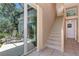 Elegant staircase with glass doors leading to a lanai at 3479 Pennyroyal Rd, Port Charlotte, FL 33953