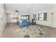 Living room with tile floors, blue couch, and view of kitchen at 40 Mark Twain Ln, Rotonda West, FL 33947