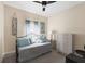 Cozy bedroom with a daybed, dresser, and beach-themed decor at 4261 Oak Terrace Cir, Port Charlotte, FL 33953