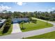 Aerial view of a single-Gathering home with a large front yard and driveway at 5214 Norlander Dr, Port Charlotte, FL 33981