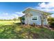 Side view of a light blue house with landscaping and a large yard at 5214 Norlander Dr, Port Charlotte, FL 33981