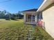 Screened porch and grassy backyard with red chairs at 563 Verona St, Port Charlotte, FL 33948