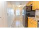 Kitchen area with black refrigerator and wood cabinets at 6800 Placida Rd # 168, Englewood, FL 34224