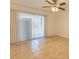 Living room with tile floors, sliding glass doors and ceiling fan at 6800 Placida Rd # 168, Englewood, FL 34224