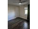 Spacious bedroom with wood-look floors, ceiling fan, and window coverings at 705 Chevy Chase Nw St, Port Charlotte, FL 33948