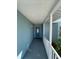 Covered walkway to the front door of the home with white railing at 9 Annapolis Ln, Rotonda West, FL 33947