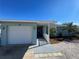 Light blue house with white garage door, walkway and landscaping at 9 Annapolis Ln, Rotonda West, FL 33947