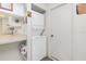 Small laundry room with a stackable washer and dryer at 9000 Griggs Rd # F, Englewood, FL 34224