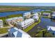 Aerial view of waterfront townhouses with private balconies and lush landscaping at 10325 Longshore Rd # 17, Placida, FL 33946
