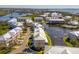 Aerial perspective of a charming townhouse community nestled near a serene lake at 10325 Longshore Rd # 17, Placida, FL 33946