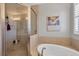 Clean bathroom with a shower, tub, and neutral tile design at 10325 Longshore Rd # 17, Placida, FL 33946