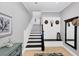 Bright entryway with staircase, built-in bench, and mirror at 10325 Longshore Rd # 17, Placida, FL 33946