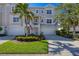 Two-story townhome with attached garage and landscaped front yard at 10325 Longshore Rd # 17, Placida, FL 33946