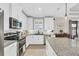 Modern kitchen with white cabinets, granite countertops, and stainless steel appliances at 10325 Longshore Rd # 17, Placida, FL 33946