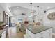 Open kitchen with granite island overlooking the living room at 10325 Longshore Rd # 17, Placida, FL 33946