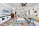 Spacious living room featuring a large sectional sofa, a ceiling fan, and ample natural light at 10325 Longshore Rd # 17, Placida, FL 33946