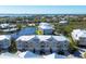 Aerial view of waterfront townhouses with a community pool and lush landscaping at 10325 Longshore Rd # 20, Placida, FL 33946