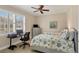 Bright bedroom with twin beds, workspace, and water view at 10325 Longshore Rd # 20, Placida, FL 33946