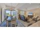 Open living and dining area with water views and modern furnishings at 10325 Longshore Rd # 20, Placida, FL 33946