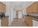 Long kitchen with light wood cabinets and granite countertops at 10549 Washington Rd, Port Charlotte, FL 33981