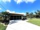 Single-story home, screened garage, light brown exterior at 110 Byron Ct, Rotonda West, FL 33947