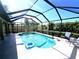 Inviting screened-in pool area with lounge chairs at 110 Byron Ct, Rotonda West, FL 33947