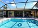 Enclosed pool area with adjacent patio and home at 110 Byron Ct, Rotonda West, FL 33947