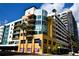 Modern urban condo building with yellow facade and parking garage at 1120 E Kennedy Blvd # 1423, Tampa, FL 33602