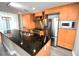 Modern kitchen with stainless steel appliances, granite countertops, and light wood cabinetry at 1120 E Kennedy Blvd # 1423, Tampa, FL 33602