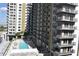 Inviting pool area with lounge chairs and building view at 1120 E Kennedy Blvd # 1423, Tampa, FL 33602