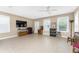 Open living area with tile floors and a TV at 12753 Sagewood Dr, Venice, FL 34293
