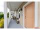 Front porch with a porch swing and a peach door at 12753 Sagewood Dr, Venice, FL 34293