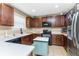 Well-equipped kitchen with dark wood cabinets and an island at 12753 Sagewood Dr, Venice, FL 34293